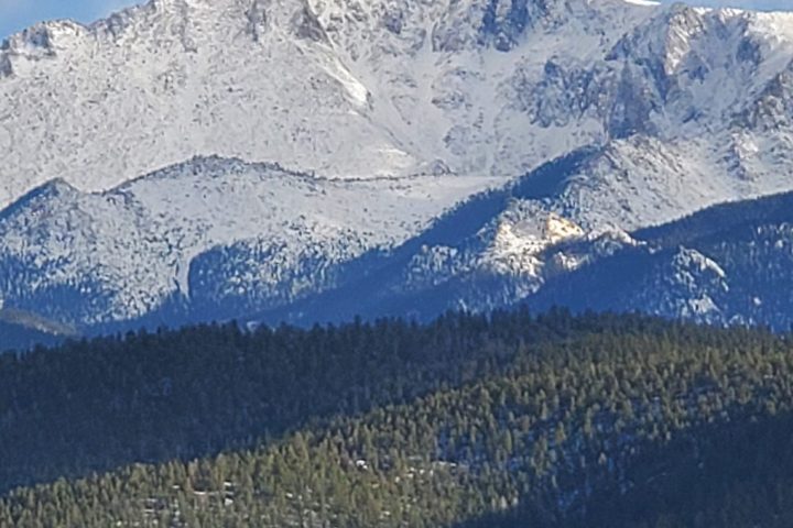 a person standing on top of a snow covered mountain